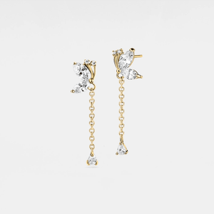 Gold earrings with clear gemstones on a light gray background