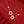 Two necklaces with butterfly pendants on a red background