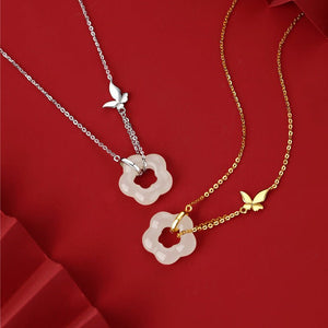 Two necklaces with butterfly pendants on a red background