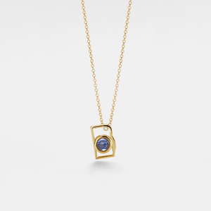 Gold necklace with a blue gemstone pendant on a white background