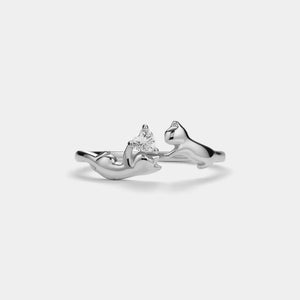 Silver ring with a diamond on a light gray background