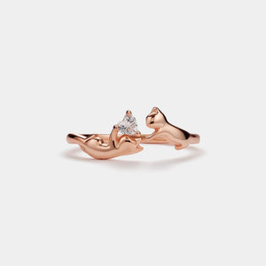 Rose gold ring with a diamond on a light gray background