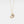 Gold necklace with a moon and star pendant on a light gray background