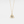 Gold necklace with a triangular pendant on a light gray background