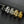 Five rings in black, silver, and gold on a dark surface