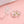 Silver floral bracelet and ring set on a pink background