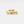 Gold floral ring on a light gray background