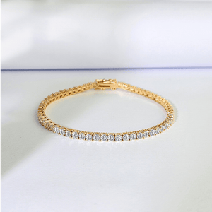 Gold bracelet with diamonds on a white background