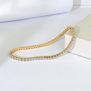 Gold and diamond bracelet on a white surface