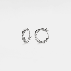 A pair of white gold-plated twisted rope hoop earrings on a white background