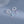 Silver cloud-shaped earrings with gemstone drops on a light blue background