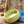Green and blue ceramic bowls with water splashing out on a textured surface.