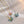 Butterfly-shaped pendants on gold and silver chains against a light background
