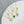Gold necklaces with colorful heart pendants on a white surface