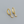 Gold hoop earrings with teardrop-shaped gemstones on a gray background