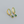 Gold hoop earrings with green gemstones on a gray background