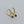 Gold hoop earrings with black teardrop charms on a gray background