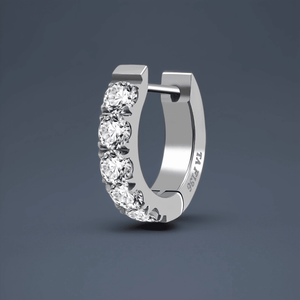 Silver hoop earring with clear gemstones on a dark gray background