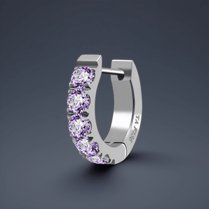 Silver hoop earring with purple gemstones on a dark gray background