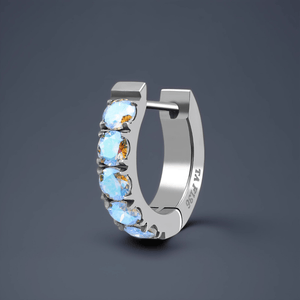 Silver hoop earring with colorful gemstones on a dark gray background