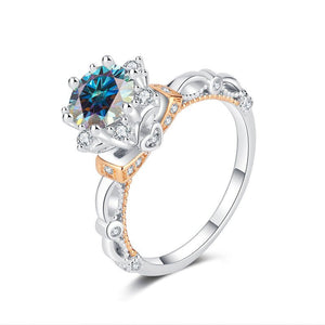 A sterling silver moissanite cocktail ring with a flower design, featuring a central moissanite gemstone surrounded by smaller ones, set on a white background.