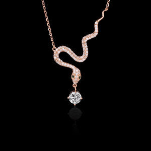 Snake-shaped necklace with a pendant on a black background