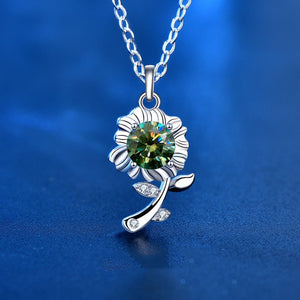 Silver necklace with a green gemstone pendant on a blue background