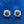 Silver earrings with green gemstones on a blue background