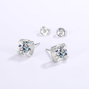Silver stud earrings with large gemstones on a white background