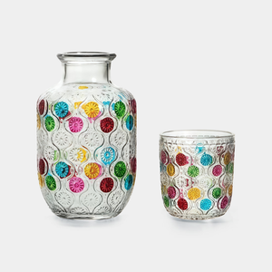 Two glass containers with colorful circular patterns on a white background