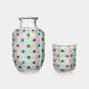 Two glass vases with colorful dot patterns on a white background