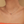 Necklace with colorful pendant worn by a person against a neutral background