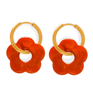 Pair of orange flower-shaped earrings with gold hoop accents on a white background