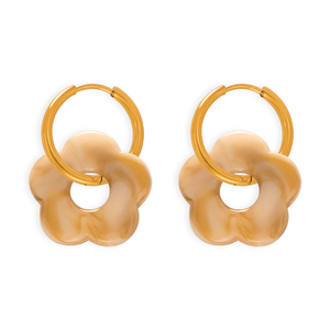 Pair of gold hoop earrings with beige flower-shaped pendants on a white background
