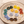 Colorful flower-shaped earrings on a decorative plate