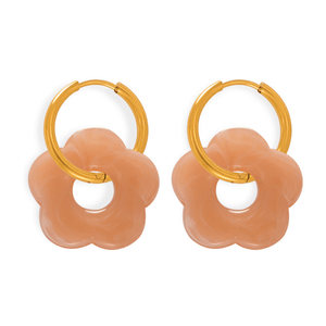 Pair of peach-colored hoop earrings with gold loops on a white background