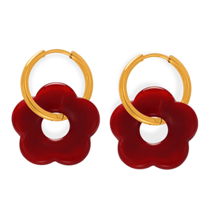 Pair of earrings with red flower-shaped drops and gold hoop designs on a white background