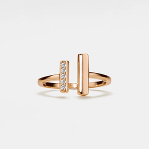 A gold-plated sterling silver ring with a hypoallergenic finish, featuring a central cubic zirconia stone surrounded by two smaller stones, displayed on a plain background.
