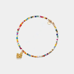 Multicolored beaded bracelet with a gold charm on a white background
