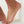 Colorful beaded anklet on a foot against a white background