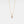 Gold necklace with a pendant on a light gray background