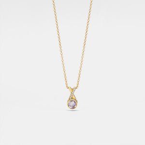 Gold necklace with a pendant on a light gray background