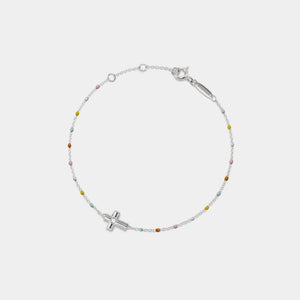 Silver bracelet with small beads and a cross charm on a white background