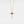 Gold necklace with a star-shaped pendant on a white background