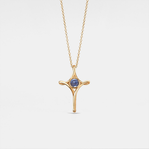 Gold necklace with a star-shaped pendant on a white background