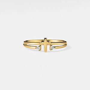 Gold ring with a cross design and small diamonds on a light gray background