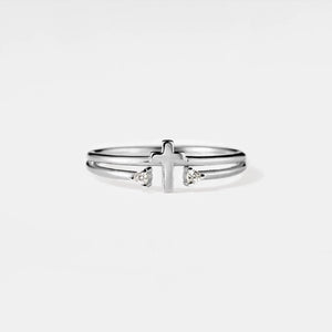 Silver ring with a cross design on a white background
