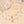 Delicate necklace with moon and star charms on a beige surface