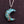 Turquoise crescent moon pendant with tree design on a dark background