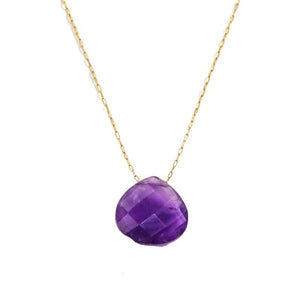 Purple faceted gemstone necklace on a gold chain against a white background